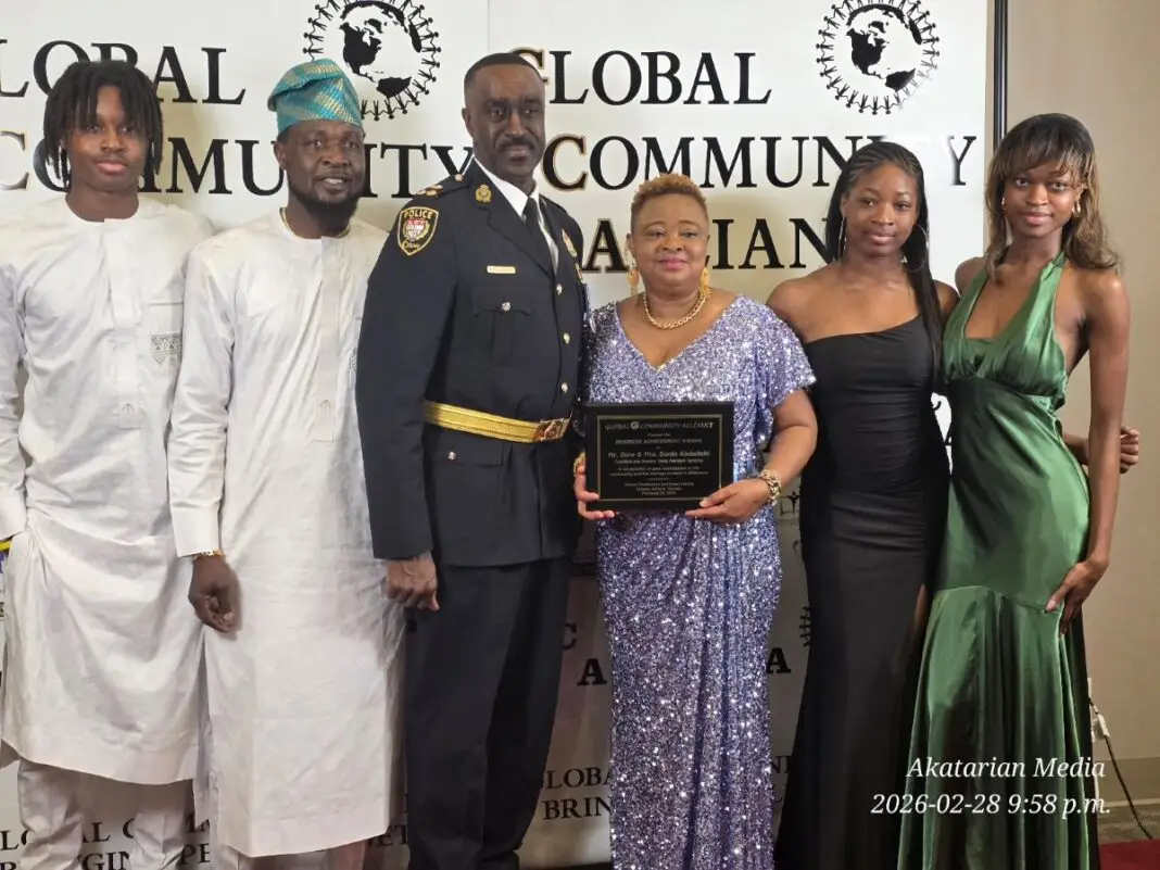 Sonia Abdullahi holds award plaque with family and deputy police chief Burnett at the GCA Award gala 2026
